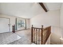 Spacious living room featuring large windows for natural light and a staircase leading to the upper level at 831 Sable Blvd, Aurora, CO 80011