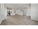 Spacious living area with wood flooring, an open layout, and modern design elements at 7360 Watercress Dr, Littleton, CO 80125
