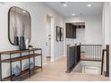 Elegant foyer with a wooden console table, decorative vases, and a view of the staircase at 3394 Backdrop Ct, Castle Rock, CO 80108