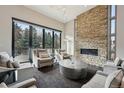 Spacious living area with a stone fireplace, modern lighting, and large windows with outdoor views at 350 15Th St, Boulder, CO 80302