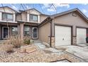Attractive townhome with attached garage and cozy front yard at 371 Smith Cir, Erie, CO 80516