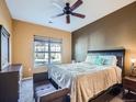 Inviting bedroom with a large window, a ceiling fan and neutral decor at 3230 Boulder Cir # 101, Broomfield, CO 80023
