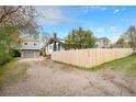 Charming home featuring a well-maintained yard, detached garage, and a new wooden fence at 5326 Lowell Blvd, Denver, CO 80221