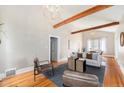 Bright living room with hardwood floors, beamed ceilings, neutral walls, and stylish furnishings, creating an inviting atmosphere at 5326 Lowell Blvd, Denver, CO 80221
