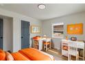 Bright bedroom with built-in workspace and cheerful orange accents at 3401 W Virginia Ave, Denver, CO 80219