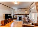 Inviting living room with hardwood floors, fireplace, and ample natural light at 1844 S Lincoln St, Denver, CO 80210