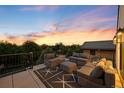 Rooftop patio with comfortable seating and stunning sunset views, perfect for outdoor entertaining at 556 Monroe St, Denver, CO 80206