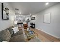 Open-concept living room seamlessly connects to the kitchen, creating a spacious and inviting area for relaxing at 3738 N Eliot St # 2, Denver, CO 80211