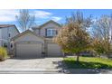 Charming stucco home with a three-car garage and well-maintained lawn at 11935 E Lake Ct, Greenwood Village, CO 80111