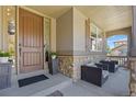 Inviting front porch with stone accents and seating area at 11935 E Lake Ct, Greenwood Village, CO 80111