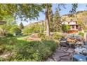 Back yard featuring a patio, mature trees, and professional landscaping at 3242 4Th St, Boulder, CO 80304