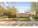 Charming mid-century home featuring a brick facade, mature trees, and a well-manicured lawn at 3242 4Th St, Boulder, CO 80304