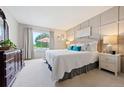 Comfortable main bedroom with a large window, panel wall, and neutral decor at 7 Shetland Ct, Highlands Ranch, CO 80130