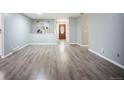 Spacious living room features new laminate flooring, fresh paint, and ample natural light at 7659 S Holland Way, Littleton, CO 80128