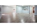 Bright living room boasts new flooring and neutral tones, offering a versatile living space at 7659 S Holland Way, Littleton, CO 80128