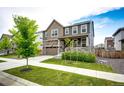 Attractive exterior view of a two-story home featuring a well-manicured lawn and inviting landscaping at 985 S Elk Way, Aurora, CO 80018