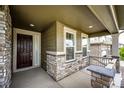 Inviting front porch with stone accents, providing a welcoming entrance to the home at 985 S Elk Way, Aurora, CO 80018