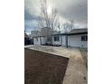 Backyard of a home with a newly installed concrete patio and fresh soil ready for landscaping at 1337 Ames St, Lakewood, CO 80214