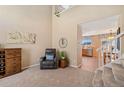 Comfortable living room area with large windows, chair and wine rack at 9230 W Indore Dr, Littleton, CO 80128