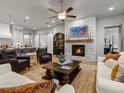 A spacious living room boasts a stone fireplace, hardwood floors, and an open layout, perfect for entertaining at 9035 S Shawnee Ct, Aurora, CO 80016