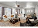 Spacious living room with lots of natural light, wood floors, and neutral decor at 9035 S Shawnee Ct, Aurora, CO 80016
