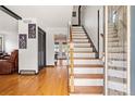 Inviting foyer with hardwood floors, staircase, and decorative glass door at 20155 E Davies Ave, Centennial, CO 80016