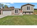 Charming two-story home with brick and siding exterior and well-maintained front yard at 8001 S Estes St, Littleton, CO 80128