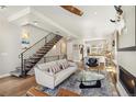 Living area with hardwood floors leads to open kitchen and staircase at 1012 Bannock St, Denver, CO 80204
