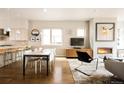 Open-concept living and dining area with hardwood floors and modern fireplace, perfect for entertaining and Gathering gatherings at 1012 Bannock St, Denver, CO 80204