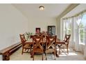Spacious dining area with a long wooden table and bright natural light at 7081 S Oak Hill Cir, Aurora, CO 80016