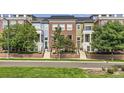 Charming multi-colored townhome featuring landscaped front yards and inviting entryways at 3411 N Xenia St, Denver, CO 80238
