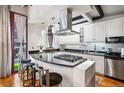 Modern kitchen with stainless steel appliances, black countertops, and a breakfast bar with stools at 1020 15Th St # 214, Denver, CO 80202
