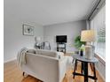 Cozy living room featuring neutral furniture, hardwood floors, and a large window at 2797 S Newton Way, Denver, CO 80236