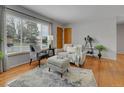 Inviting living room with large window, hardwood floors, and neutral decor at 2797 S Newton Way, Denver, CO 80236
