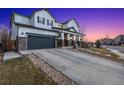 Attractive two-story house with a paved driveway leading to a two-car garage and a covered front porch at 2342 Hickory Pl, Erie, CO 80516