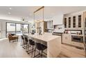 Bright, open kitchen with large island, modern appliances, and sleek cabinetry at 374 S Humboldt St, Denver, CO 80209