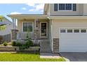 Charming home with a covered front porch, stone accents, and an attached garage at 19524 Montview Dr, Aurora, CO 80011