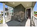 Covered front porch showcasing stone accents and modern design at 20871 E 60Th Ave, Aurora, CO 80019