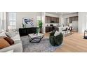 Comfortable living room featuring modern decor and seamless flow to the kitchen at 20871 E 60Th Ave, Aurora, CO 80019