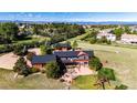 A captivating aerial view showcases the property's patio, yard, and surrounding greenery at 6191 S Olathe St, Centennial, CO 80016