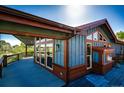 Home exterior with covered deck, featuring beautiful wood trim, railings, and outdoor living at 6191 S Olathe St, Centennial, CO 80016