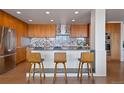 Modern kitchen featuring sleek cabinetry, stainless steel appliances, and stylish barstool seating at 1020 15Th St # 42A, Denver, CO 80202