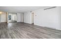 Living room featuring wood floors, white walls, and neutral finishes at 1020 15Th St # 15G, Denver, CO 80202