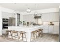 Modern kitchen with stainless steel appliances and large island at 9385 E 58Th Dr, Denver, CO 80238