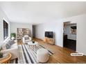 Bright living room with hardwood floors, white walls, and comfortable seating area at 945 W 8Th Avenue Dr, Broomfield, CO 80020