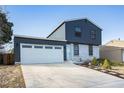 Inviting home featuring an attached two car garage and a long concrete driveway at 17233 E Princeton Dr, Aurora, CO 80013
