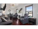 Inviting living room with hardwood floors, a fireplace, and comfortable leather seating at 17233 E Princeton Dr, Aurora, CO 80013
