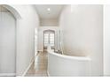 Bright hallway with tiled flooring and vaulted ceilings featuring archways and a set of french doors at 7400 W Grant Ranch Blvd # 52, Littleton, CO 80123