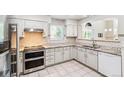 Kitchen with stainless steel oven, granite countertops, and white cabinets at 7400 W Grant Ranch Blvd # 52, Littleton, CO 80123