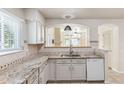 Kitchen featuring a granite countertop and breakfast bar at 7400 W Grant Ranch Blvd # 52, Littleton, CO 80123